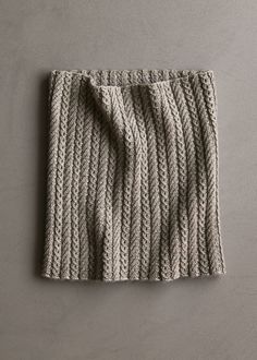 a knitted scarf on a gray background