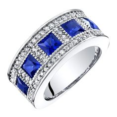 So much amazing artistry really makes this ring truly unique with its four princess-cut lab-created Blue Sapphire stones; free shipping from Peora Sapphire Birthstone Ring, Sapphire Anniversary Ring, Channel Ring, Sapphire Anniversary, Sapphire Birthstone, Sapphire Stones, Eternity Rings, Tiny Beads, Promise Rings For Her