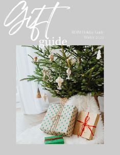 a christmas tree with presents under it and the words gift guide