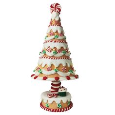 a ceramic christmas tree with candy canes on top