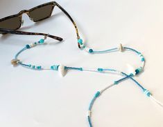 Miyuki Beaded Glasses Chain,Real Seashell Sunglasses Strap, Eye Glass Holder,Boho Hippie Mask Chain,Summer Jewelry,Beach Seed Beads Lanyards If you are tired of playing hide and seek with your glasses and masks, there is a colorful news for you! Thanks to our handmade eyeglass straps, which make it almost impossible to lose glasses and give life to boring frames, you can wear your glasses comfortably by hanging them on your neck when not wearing them. It completes your full BOHO chic look! You c Beach Season Jewelry With Beaded Chain, Summer Beaded Shell Necklaces, Handmade White Glasses Chains For Beach, Handmade White Glasses Chains For The Beach, Handmade White Glasses Chains For Summer, White Glass Necklaces For Beach, White Glass Necklaces For The Beach, Summer Shell Beaded Necklace, Summer Beach Glass Necklaces