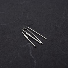 Elevate your style with these Handmade Sterling Silver Threader Earrings. Crafted with precision, these minimalist earrings feature two sterling silver wires--one at 1.5mm thickness soldered to another at 1mm. The sleek, modern design elegantly threads through your earlobe, creating a striking yet simple statement piece that measures 40mm in height. Choose between a subtle matte finish for a soft, understated look or a polished shiny finish for added brilliance. Whether you're dressing up for a Modern Sterling Silver Linear Earrings With Ear Wire, Simple Sterling Silver Threader Earrings For Everyday, Minimalist Long Drop Linear Earrings For Pierced Ears, Minimalist Long Drop Linear Earrings, Minimalist Silver Long Drop Threader Earrings, Simple Silver Sterling Threader Earrings, Silver Minimalist Threader Earrings With Ear Wire, Minimalist Dangle Linear Earrings, Minimalist Sterling Silver Linear Earrings Nickel-free