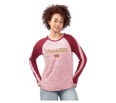 a woman wearing a red and white shirt with the word commander on it's chest