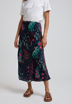 To create a feminine silhouette, the Ivy midi skirt is a stunning addition to your wardrobe. Boasting the Wonderland print, with floral hues in bold colour palette. A pull-on midi skirt with elasticated waist band; comfort sits alongside chic to make this the perfect all-rounder.   Wash and iron inside out. Wash with similar colours, reshape whilst damp. 100% Satin Sourced in India  Cool machine wash only. Wash inside out and with similar colours Silk Floral Print Flowy Maxi Skirt, Elegant Printed Skirt, Elegant Printed Summer Skirt, Silk Floral Print Midi Skirt, Silk Flowy Skirt With Floral Print, Silk Floral Print Flowy Skirt, Silk Floral Print Skirt, Printed Relaxed Midi Skirt, Elegant Floral Print Maxi Skirt