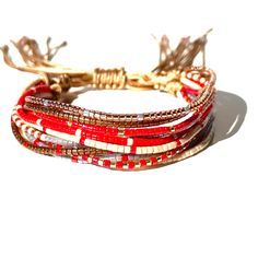 three red and white bracelets on top of each other