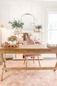 a wooden table sitting in front of a window with potted plants on top of it