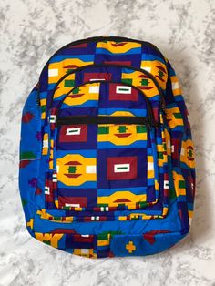 With bold colors and patterns these book bags will be the talk of the town. -Each bag has four pockets to hold all supplies needed for the day. -Adjustable straps-17 inches tall Need something a little smaller, check out our Small Ankara Book Bags. Multicolor Everyday Backpack With Adjustable Straps, Multicolor Backpack With Adjustable Straps For Everyday Use, Multicolor Rectangular Backpack For Trip, Multicolor Laptop Bag For Trips, Multicolor Rectangular Backpack With Zipper Pocket, Multicolor Everyday Bag With Multiple Pockets, Multicolor Everyday Bags With Multiple Pockets, Square Travel Backpack For Back To School, Square Backpack For Travel And Back To School