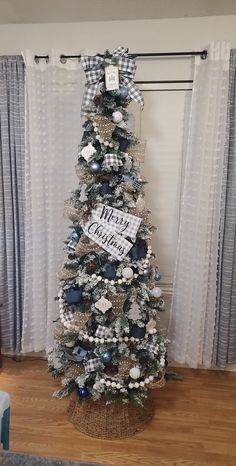 a decorated christmas tree in front of a window