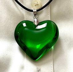 Large Emerald green puff crystal heart pendant, made of highest quality glass. Beautiful emerald green heart, classic pendant to be used for any occasion, symbol of love and joy Size of heart:  1 3/4x1 3/4inches (4.5x4.5cm) Leather cord 19" (48cm)long including extender Total Length of necklace. 11 inches (28cm) Green Aesthetic Clothes, Green Heart Necklace, Green Necklaces, Glass Heart Necklace, Green Choker, Necklace Emerald, Heart Christmas, Green Pendant, Big Necklace