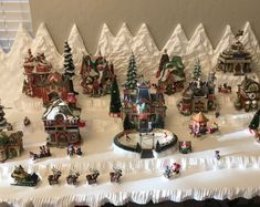 a christmas village is displayed on a table