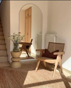 a chair and table in a room with stairs