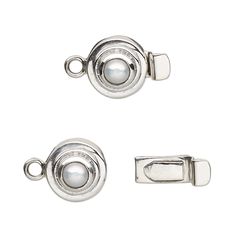 two metal clasps with white pearls on each side and an oval button at the end