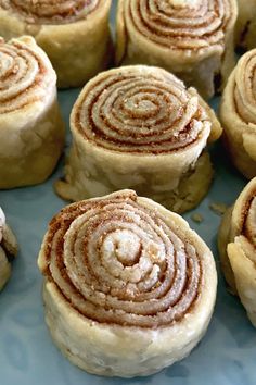 some cinnamon rolls are on a blue plate