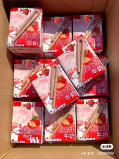 there are many boxes of strawberries and chopsticks in the same box together