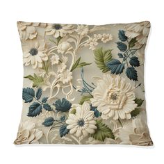 an embroidered pillow with flowers and leaves on it