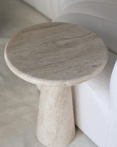 a marble table sitting on top of a white couch