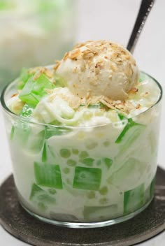 a dessert with ice cream and celery in a glass dish on a plate