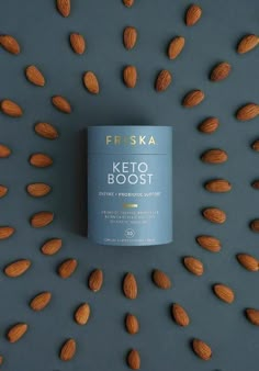 a can of friskka keto booster surrounded by almonds on a grey background