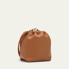 Valentino Garavani bucket bag in soft lambskin leather Shoulder strap with VLOGO accent  Drawstring and clasp closure  Interior, slip pocket Lining: Leather Approx. 10.2"H x 13.4"W x 3.9"D Made in Italy Classic Crossbody Bucket Bag In Soft Leather, Classic Soft Leather Crossbody Bucket Bag, Leather Bucket Bag With Removable Pouch For Evening, Luxury Soft Leather Bucket Hobo Bag, Evening Leather Bucket Hobo Bag, Leather Bucket Hobo Bag For Evening, Leather Bucket Bag For Evening, Cognac Bucket Bag With Dust Bag Included, Travel Bucket Bag With Gold-tone Hardware