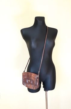 "Vtg leather and vegan leather (mixed materials) cognac brown patches 80s bag. Shoulder bag, crossbody purse. Patched adventure flap bag. The interior not lined, but inside are textile as leather bottom base. With 2 compartments and 1 zippered compartment inside. condition: Good vintage condition. No damages. The closure and zippers works well. Measures: Width 19 cm/ 7.4\" in Height 17,5 cm/ 6.8\" in strap length 119 cm / 46.4\" in" Vintage Brown Crossbody Flap Bag, Brown Leather-backed Crossbody Flap Bag, Brown Leather Backed Crossbody Flap Bag, Brown Leather Backing Crossbody Flap Bag, Brown Leather Backing Crossbody Shoulder Bag, Italian Bags, Brown Leather Crossbody Bag, Women Purse, Brown Handbag