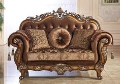 an ornate couch with pillows on it in a living room