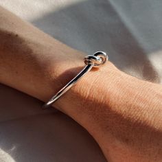 Our Love Knot Bangle is elegant and adjustable bangle with cute infinity knot in the middle. Product Details Hypoallergenic, gold or silver plated stainless steel Water proof and Sweat proof Knot Bangle, Infinity Knot, Swimwear Store, By The Ocean, Adjustable Bangle, Never Change, Love Knot, 925 Sterling Silver Chain, Sweat Proof