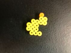 two yellow buttons sitting on top of a black surface