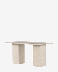 a white table sitting on top of a cement block