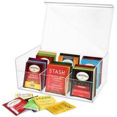 a clear box filled with lots of different types of teas and packets on top of each other