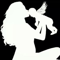 the silhouette of a woman holding a baby in her arms and drinking from a bottle