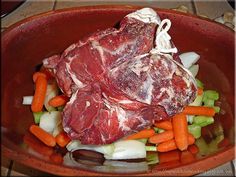 some meat and vegetables in a bowl on a table