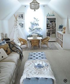 a living room filled with furniture next to a white table and chair covered in blankets