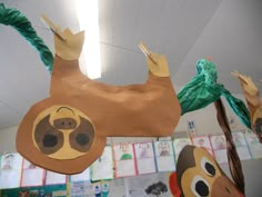 some paper mache animals hanging from the ceiling