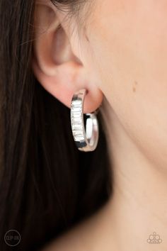 a close up of a person wearing some kind of earring on their ear and looking at the camera