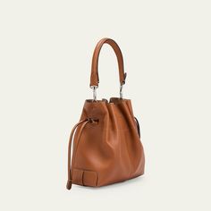 Tod's "Di" bucket bag in soft full grain leather  Detachable tubular top handle  Detachable, adjustable crossbody strap Can be worn as a top handle or crossbody bag  Drawstring closure  Distinctive Tod's logo stamped on the front Lining: Leather Approx. 6.6"H x 7.8"W x 3.9"D Made in Italy Leather Bucket Satchel For On-the-go, Cognac Bucket Bag For On-the-go, Classic Leather Bucket Bag With Detachable Handle, Classic Bucket Satchel With Detachable Strap, Everyday Cognac Bucket Bag With Detachable Strap, Classic Bucket Satchel With Adjustable Strap, Classic Bucket Bag With Adjustable Strap, Calf Leather Bucket Bag With Handle Drop For Travel, Cognac Bucket Bag With Detachable Handle