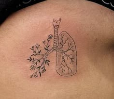 a woman's stomach with a drawing of a lungs and flowers on the side