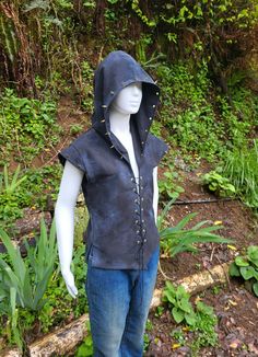 This one of a kind  unisex vest is a sort of distressed dystopian style mixed with punk/goth style. It is made of sturdy black cotton twill, lined with the same fabric so it is fairly thick. It is a lace-up vest with metal grommets and cotton waxed cord down the front, as well as panels with lacing in the back to tighten as needed at the waist. It has a hood and shoulder flanges, both decorated with gold metal spikes (not super sharp). The fabric is "distressed" to give it a worn look so it is lightly frayed here and there, plus I have added acrylic paint to add some aging and "stains" to it. Great for a costume piece or just a unique vest for those who like to stand out! Hand wash only, air dry. The spikes a screw-in and are on tightly but can be tightened with a small Philip's screwdrive Unique Vest, Jacket Art, Coos Bay, Metal Spikes, Goth Style, Hooded Vest, Punk Goth, Goth Fashion, Kids Costumes