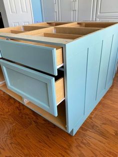 an unfinished kitchen cabinet with drawers in it