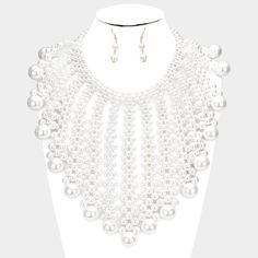 Pearl Bubble White Collar Statement Necklace SetItem: Necklace & Pierced EarringsBrand: Sparkle ARMANDColor: White, SilverLength: 18" + 3" Long (inches) Decor Size: 7.5" (inches)Earrings: 1.75" Long Fastening: Lobster Clasp Metal: Alloy, Lead & Nickle FreeMaterials: Metal, Faux Pearls Theme: Statement, Couture, Evening All Measurements are Approximate Sold As One Individual Necklace and One Matching Pair Of Pierced Earrings Cheap Pearl Chain Costume Necklace, Luxury White Festive Necklaces, Cheap White Statement Beaded Necklaces, Luxury White Pearl Necklace For Festivals, Luxury White Beaded Necklaces For Formal Occasions, Affordable White Statement Beaded Necklaces, Cheap White Statement Pearl Necklace, Luxury White Beaded Statement Necklaces, Saturn Necklace