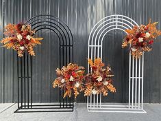 three metal archways decorated with flowers and foliage