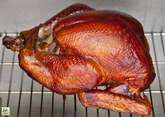 a whole turkey sitting on top of a grill