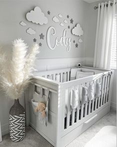 a baby's room with white furniture and decorations