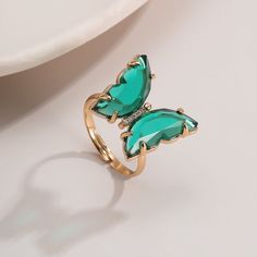 Description: Chic Zirconia Butterfly Ring Specifications: Size: #7 adjustableWeight: 0.11 oz/pcsMaterial: Zircon, Copper, 18k GoldColor: red/pink/purple/green/white/black/amber/turquoise Add a touch of whimsy and elegance to your everyday attire with our Chic Zirconia Butterfly Ring! Crafted with sparkling zirconia stones, this ring will surely catch anyone's eye. Embrace your inner fashionista with this must-have accessory. Fly high with style! 🦋✨ Rose Violette, Butterfly Ring, Enamel Bracelet, Copper Color, Green Crystals, Exquisite Jewelry, Purple Green, Black Rings, Unique Rings