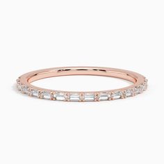 a rose gold wedding band with baguettes on the side and diamonds in the middle