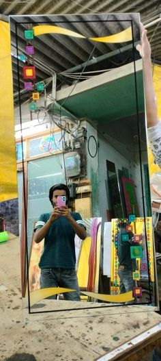 a man taking a selfie in front of a mirror with his reflection on it