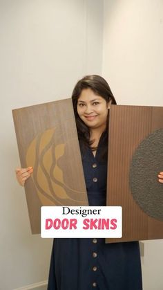 a woman is holding up two different types of wood panels with the words designer door skins on them