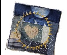 a patchwork piece with a heart on it's side and stars in the middle