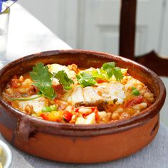 a pot filled with food sitting on top of a table