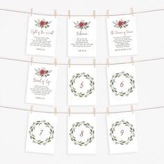 the wedding stationery is hanging on a clothes line with flowers and greenery around it