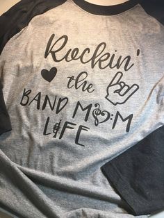 a grey and black shirt that says rockin'the bd band mom life